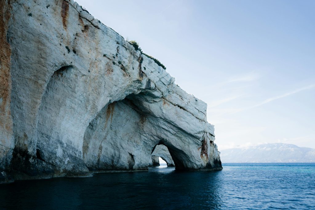 Explore the stunning blue caves on the coast of Zakynthos, Greece, with serene sea views.