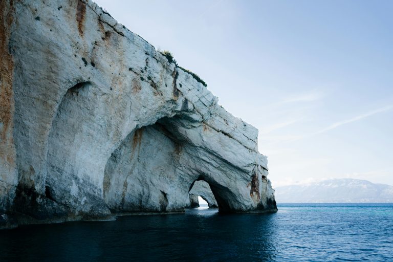 Explore the stunning blue caves on the coast of Zakynthos, Greece, with serene sea views.