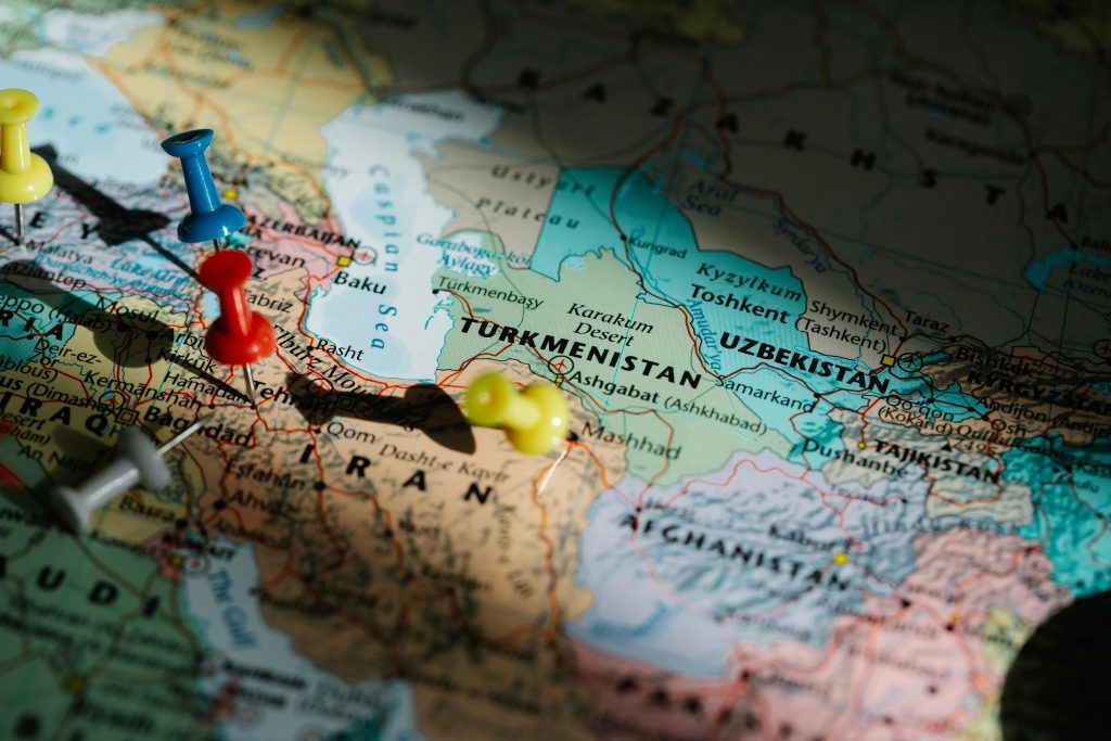 Colorful pushpins marking locations on a detailed map of Central Asia.